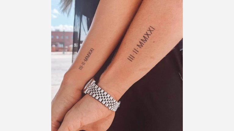 Roman Numeral Arm Tattoo